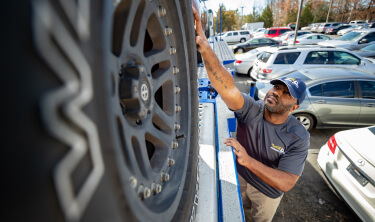 A supplier working with a vehicle.