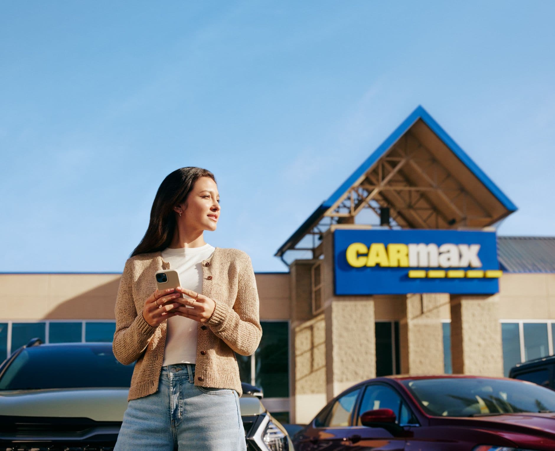 woman at carmax location with her phone